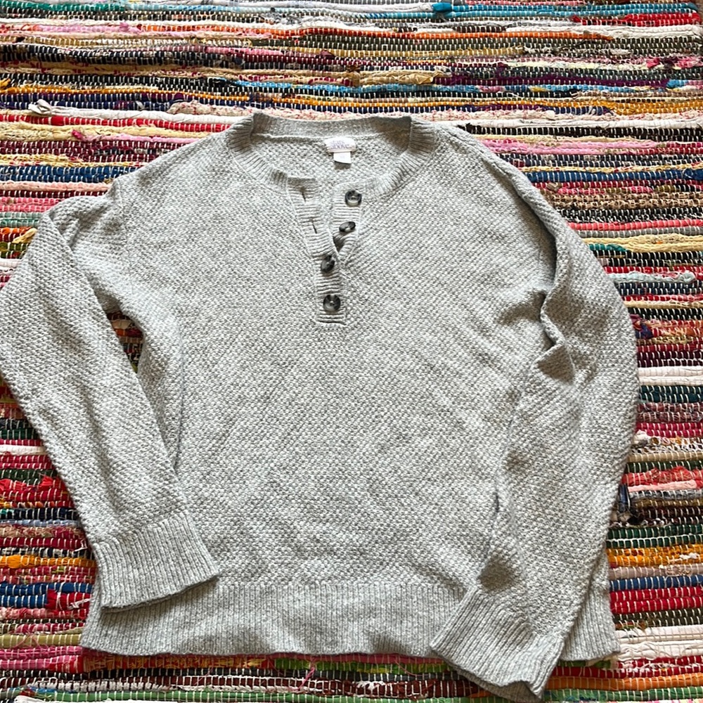 stars above light grey sweater with buttons